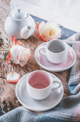 Pure coffee or tea set. A pair of elegant porcelain light gray and pastel pink cups on a cozy background