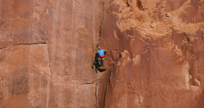 Aerial shot of man rock climbing extreme multi pitch climb 