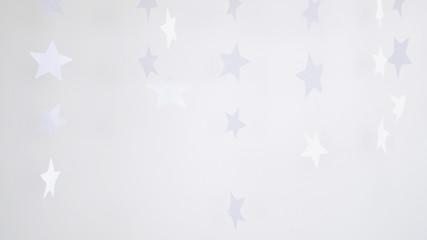 Paper stars hanging and rotating decoration on a white background. Christmas concept.
