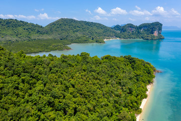 Aerial drone view of beautiful lush green tropical islands with remote, empty bays and beaches