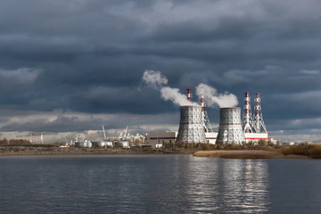 Fototapeta premium thermal power plant on the Baltic sea against the dramatic sky