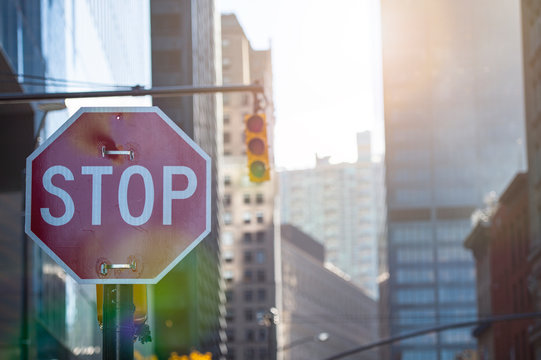 Close-up view of some skyscrapers in Manhattan with a red stop sign in the foreground, New York, United States.