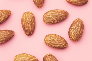 Almond, Nuts on pink background.