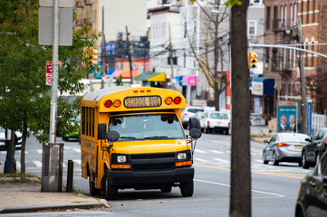 A school bus on the streets of the Bronx, New York city, USA. The Bronx is the northernmost of the five boroughs of New York City, in the U.S. state of New York. - obrazy, fototapety, plakaty