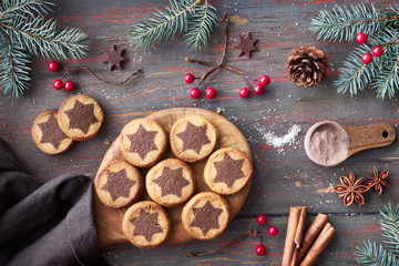 Christmas cookies with chocolate star pattern with choco stars, cinnamon and decorated fir twigs