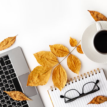 Workspace with laptop, coffee cup, glasses and notebook. Stylish office desk. Autumn concept. Flat lay, top view, copy space..