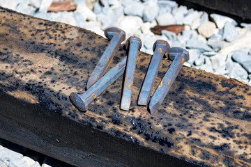 Close up of railroad spikes on wooden sleeper