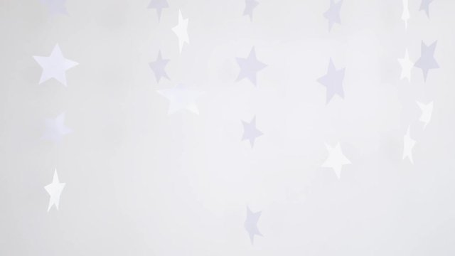 Three paper snowflakes hanging and rotating decoration on a white background. slow motion. Christmas concept. 3840x2160