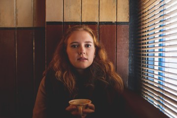 Woman holding a coffee mug in cafe