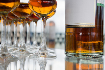 Dear Scotch whiskey in branded glasses on a high leg.