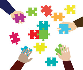 Hands and pieces of puzzles on a white background. Business and construction. Command and merge.