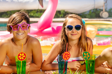 Happy boy and girl having fun during pool party