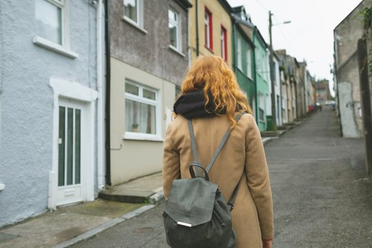 Redhead woman standing on alley street