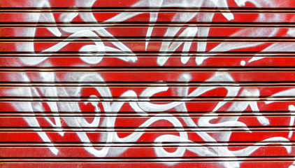 Red garage gate with graffiti