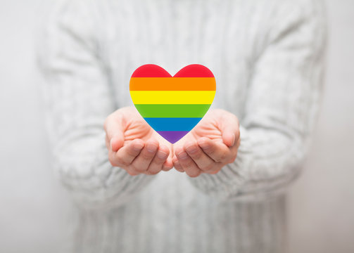 LGBT rainbow heart symbol of love in hands 