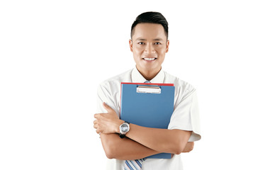 Portrait of young handsome Asian male office manager holding documents and smiling at camera cheerfully on white background