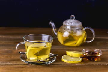 Glass Cup and Glass Teapot with Hot and Tasty Lemon and Ginger Tea Hot Autum Winter Drink Close Up