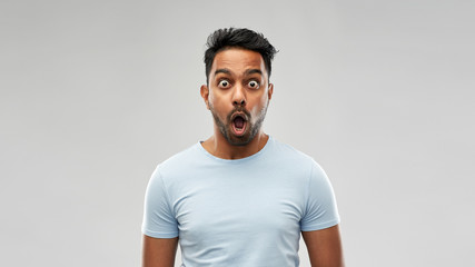 emotion, expression and people concept - shocked or scared man in t-shirt over grey background - obrazy, fototapety, plakaty