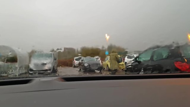 Rain drops fallung on the car window during storm