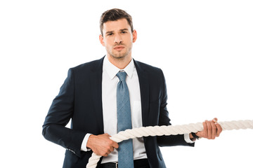 tense businessman pulling rope and looking at camera isolated on white