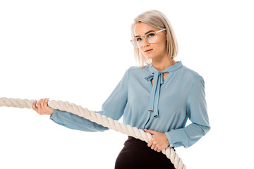 Beautiful blonde businesswoman in glasses pulling rope isolated on white