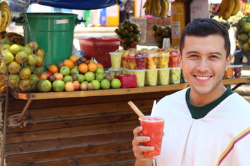 Joyful ethnic male at fruit market