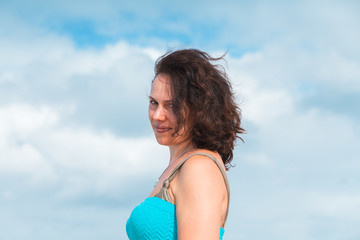 Smiling young adult Caucasian woman in blue