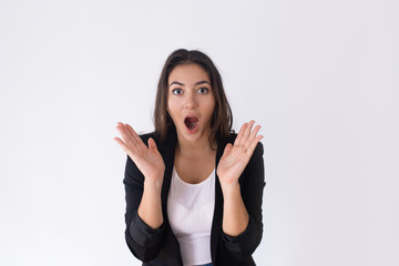 Shocked pretty Caucasian girl spreading hands with open mouth. Young female manager reacting to...