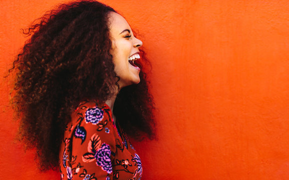 Side View Of Young Woman In Floral Dress Laughing