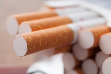 closeup of cigarettes in cigarettes pack  on wooden table background