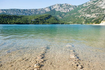 Stones in the water show the route. Artificial lake of Sainte-Croix-du-Verdon. Provence. France.