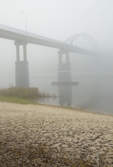Over the river there is a dense fog.