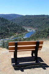 isolated park bench that overlooks river canyon