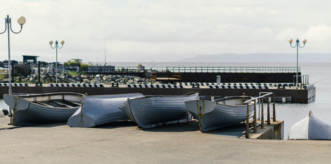 Wooden boats in the harbor at city marina port.
