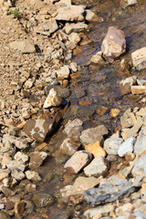 Mountain stream on the stones in nature