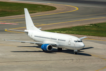 Modern passenger civil airplane taxiing at international airport