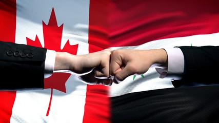 Canada vs Syria conflict, international relations, fists on flag background