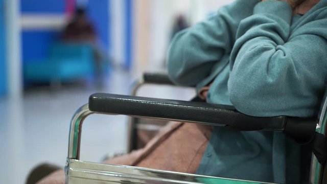 Closeup elder patient woman hand on wheelchair waiting doctor in hospital