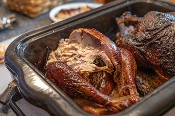 two smoked turkeys ready for slicing for Thanksgiving dinner