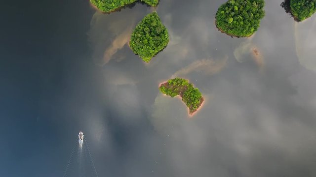 Amazing aerial view of a man made lake with a supply boat and islands. Petit saut Guiana