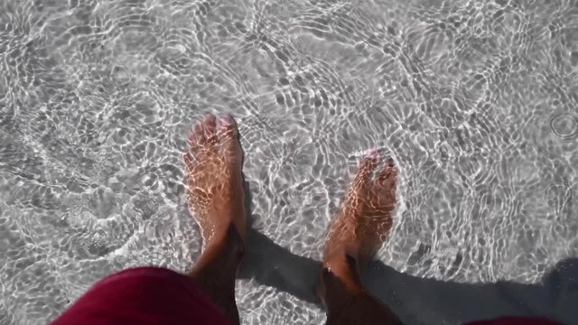 Feet in beautiful shallow water