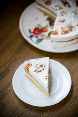 a piece of homemade sweet cake with cream and canned apricots
