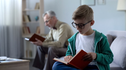 Fototapeta na wymiar Smart kid in eyeglasses and old man reading books, education for different ages