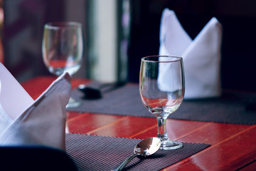 Glasses and plates are neatly placed on the restaurant table