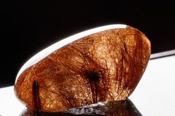 Macro mineral stone Rutile in quartz on background