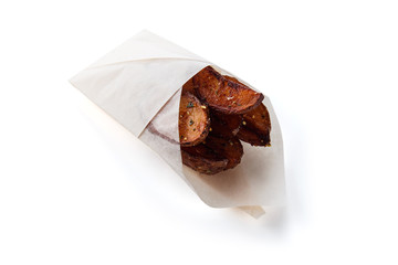 French fries in a gift wrapping on a white background (close top view)