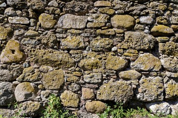 The wall of the ancient fortress is made of stones. Texture.