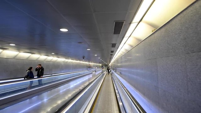 BARCELONA, SPAIN - MAY 2018: Tourist walk on tapis roulant in subway station
