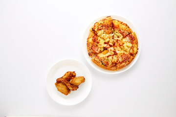 Pizza and fried chickens are white plate