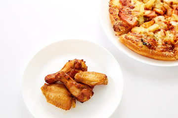 Pizza and fried chickens are white plate